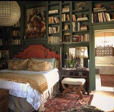 a bedroom with green walls and lots of bookshelves