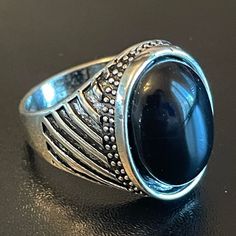 a ring with a large black stone in it