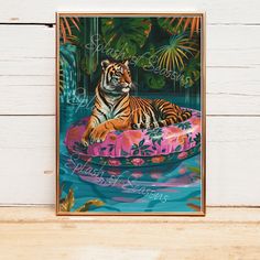 a tiger sitting on top of a pink raft floating in the water with palm trees behind it