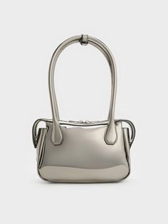 With a high-shine mirror-metallic finish, this Bosie top handle bag in pewter will set you apart wherever you go. Featuring two elongated handles and a distinctive shape, this cute and chic piece is an updated iteration of the classc lady-like bag style. Equipped with a zip closure that will keep your belongings secure, it exudes a modern femininity that can be dressed up or down to suit the occasion -- it will work well for both work days and the weekends. Charles Keith, Bag Style, Handle Bag, Top Handle, Fashion Bags, Top Handle Bag, Handles, Mirror