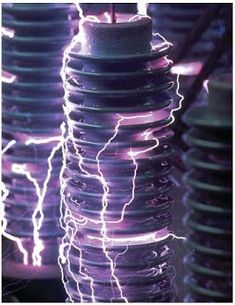 electric wires are shown in this image with purple hues and white lights behind them