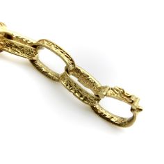 This vintage 18k gold bracelet is reminiscent of childhood paper garlands, but in the most sophisticated sense! The links are oval loops, concave to add even more dimensionality, with an ornate pattern that reads like brocade. The pattern is abstract but catches the light and adds real beauty to the piece. The brocade feels similar to a Florentine finish and gives the bracelet a lovely glow. The curved, concave nature of the links allows them to lie into each other nicely, which is what makes the bracelet seem so fluid. When worn, the bracelet flows up and down, riding gracefully on the wrist.  The bracelet is 7 7/8”, but because of the open links, fits like slightly smaller size. A link could easily be removed to fit a smaller wrist, which would take the length down by 3/4”. Each link is Gold Oval Link Oyster Bracelet Gift, Luxury Engraved Oval Link Bracelet, Yellow Gold Link Bracelet In Brass, Elegant Hammered Link Jewelry, Elegant Brass Bracelets With Rectangular Links, Heirloom Yellow Gold Oval Link Bracelets, Heirloom Yellow Gold Oval Link Bracelet, Gold-colored Brass Oval Link Bracelet, Gold Oval Link Bracelet In Brass