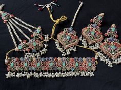 The jewelry set being offered here is a traditional Noratan bridal set, often worn during weddings or other formal occasions in Indian and Pakistani cultures. It is a multicolor set that can complement with many outfits and can be worn at many formal occasions. Here's a detailed description of this Navratan set  - **Noratan Bridal Choker The choker is  grand and intricate, typical of Noratan designs. It  features a combination different color embedded beads on a golden background.  The design is Traditional Jewelry Sets With Motifs For Festive Season, Multicolor Kundan Bridal Earrings With Intricate Design, Traditional Festive Jewelry Sets With Motifs, Multicolor Bridal Earrings With Intricate Design For Diwali, Multicolor Intricate Bridal Earrings For Diwali, Traditional Kundan Sets With Motifs, Multicolor Bollywood Bridal Earrings With Intricate Design, Traditional Meenakari Jewelry Sets, Traditional Multicolor Meenakari Jewelry Sets