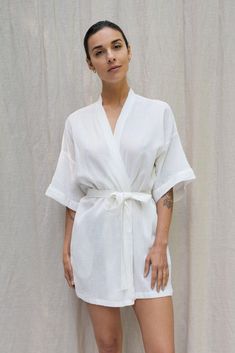 Inspired by our founders' first trip to Bali, the Bali Robe embodies our "bedroom to beach" concept. Crafted from lightweight fabric with a captivating texture reminiscent of rippled water. This versatile robe transitions seamlessly from home attire to beach cover-up, becoming a staple in your daily wardrobe. Drop Sleeve Relaxed fit Above the knee length Tie waist belt Pockets White Relaxed Fit Cover-up For Loungewear, White Relaxed Fit Kimono For Loungewear, Summer Relaxed Fit Robe For Loungewear, Summer Relaxation Robe With Kimono Sleeves, Summer Wrap Robe For Lounging, Summer Wrap Robe For Relaxation, Summer Linen Lounging Robe, Summer Lounging Wrap Robe, Summer Sleep Robe In Wrap Style