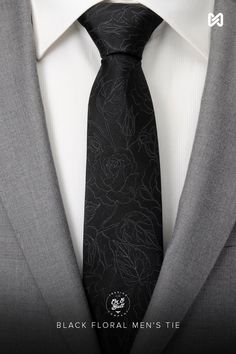 A beautiful yet masculine black floral design creates the subtle pattern on this black men's tie. Our tie will maintain its shape and hold a perfect knot thanks to the durable yet soft 100% Silk. A perfect accessory that can be worn for formal events or special occasions. Pairs well with our Soft Gray Floral Pocket Square. Elegant Black Standard Tie And Suit Accessories, Elegant Black Suit And Tie Accessories For Black-tie Events, Elegant Black Suit And Tie Accessories, Elegant Black Ties For Black-tie Events, Elegant Black Ties For Semi-formal Occasions, Semi-formal Black Suit And Tie Accessories, Black Standard Tie For Wedding Suits, Black Ties For Black-tie Events, Black Tie For Black Tie Events