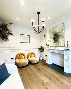 a living room filled with furniture and a fire place in the middle of the room