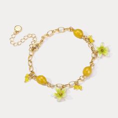 Experience the refreshing and invigorating essence of the Lemon Bracelet. Embrace nature with its sweet, juicy lemon design that evokes memories of sunny days, tropical vacations, and cool breezes. Let its vibrant flowers and fruit design add a touch of summer zeal to your style. Embrace the zesty spirit of summer and Celebrate the luxurious pleasures of nature's bounty with this delightful Lemon Bracelet! DETAILS Plating: 18K Gold Materials: 18K Gold on Brass, Enamel, Cubic Zirconia Measurement Trendy Flower Shaped Jewelry For Vacation, Trendy Flower Jewelry For Vacation, Trendy Flower-shaped Jewelry For Vacation, Trendy Flower-shaped Vacation Jewelry, Delicate Gold Bracelets For Summer, Elegant Gold Bracelets For Vacation, Dainty Beach Jewelry For Spring, Dainty Spring Beach Jewelry, Summer Flower Charm Bracelet Jewelry