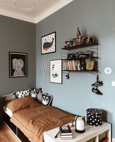 a bed sitting in a bedroom next to a wall with many pictures on the walls