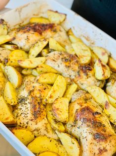 chicken and potatoes in a baking dish with seasoning