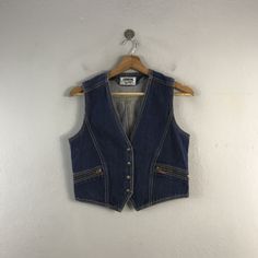 PLEASE READ DESCRIPTION BELOW BEFORE BUYING👇🏻 *ITEM:Vintage Conron Denim Vest *ITEM DETAILS: 👇🏻 Please be aware that all vintage items will usually show a few signs of wear or fading due to age, but anything visible such as stains or holes, and serious flaws have been photographed.For any further information on this item please contact us and we will be happy to help. *SIZE:SMALL *ACTUAL SIZE MEASUREMENT: 👇🏻 *PIT TO PIT(WIDTH):18"INCHES *LENGTH(FROM SHOULDER): 20"INCHES  *ALL MEASUREMENTS ARE TAKEN WITH THE GARMENT FLAT ON THE GROUND *VIEW FULL SHOP HERE: https://www.etsy.com/shop/Tracstore *SHIPPING: (WITH ONLINE TRACKING NUMBER ) *DHL EXPRESS SHIPPING:4-6 BUSINESS DAYS *Don't Worry About Customs Tax or Fees. I usually Declare As 'Gifts' And Low Value  *ANY QUESTION WILL ANSWER WITH Outerwear Outfits, Mens Formal Vest, Fashion Vest, Formal Vest, Mens Vests, Outerwear Outfit, Mens Formal, Sleeveless Jacket, Vest Fashion