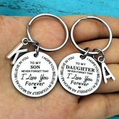 two personalized keychains with names on them in the shape of people's names