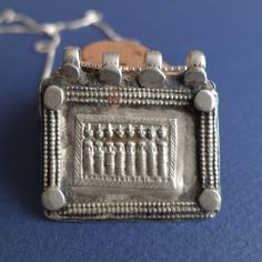 Wonderful tribal pendant from India. Silver tribal square pendant from India Rough and powerful jewelry from the Gujarat state. A depiction of the eight mothers (ashtamatrika: Brahmanai Bhairavi Chamundi Vaisnavi Varahi Mahesvari Indrani Kaumari) personified shakti powers of the Devas (Gods). The pendant has been reshaped by silver masters from its original version to transform it into a charm as shown in the 4th picture. Silver chain is included. Measures: Pendant is 3.7 x 3.5 centimeters. Weig Square Pendant, Silver Pendant, Silver Chain, India, Square, Chain, Pendant, Silver