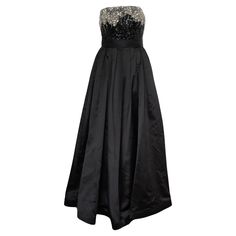 The Vintage Oscar de la Renta evening gown is a true masterpiece of elegance and glamour. Crafted from luxurious black silk, this strapless gown drapes beautifully, exuding a sense of timeless sophistication. The bodice features Swarovski (silver, gold, clear) and black sequin embellishments that add a touch of opulence, shimmering delicately as you move. This gown has a detachable belt and a built in corset that is 9.5” long, with 3 hooks inside. With its maxi length and tailored silhouette, it Maxi Evening Dress, Strapless Gown, Maxi Dress Evening, Dress Gown, Black Sequins, Vintage Silk, Black Silk, Evening Gown, Formal Event