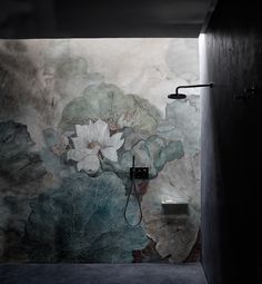 an artisticly designed bathroom with flowers painted on the wall