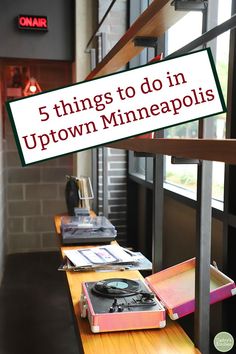 there is a sign that says 5 things to do in up town minneapolis on the table