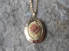 Beautiful cameo locket!!!  The cameo is a gorgeous Rose, choose pink or brown, many other styles and colors available in my shop, so please do browse!!!  The locket is gold plated, victorian style with beautiful scroll on the front and back.  It can hold two photos, keepsakes, or even your daily medication or vitamins!!! The chain is 20" gold plated link chain with a lobster claw clasp!!! Perfect  for Brides or Bridal parties.  Makes a unique memorable gift for any occasion!!!  Timeless classic Pink Gold Necklace Jewelry, Unique Locket Necklace Vintage, Oval Rose Design Jewelry For Wedding, Vintage Rose Gold Locket Necklace For Wedding, Rose Gold Vintage Charm Locket Necklace For Wedding, Rose Gold Cameo Jewelry Gift, Rose Gold Cameo Jewelry For Gifts, Vintage Rose-colored Jewelry For Gifts, Vintage Pink Jewelry For Keepsake