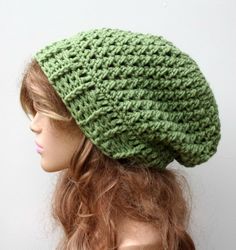 a close up of a mannequin head wearing a green knitted beanie