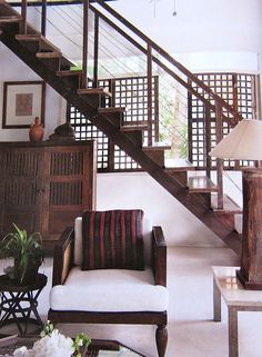 a living room filled with furniture and a stair case