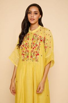 Yellow dress with floral embroidery around the neckline and mandarin collar. Comes with inner slip.
Component: 2
Embroidered
Neckline: Mandarin Collar
Sleeve Length: Three Quarter
Fabric: Chanderi Cotton
Color: Yellow
Front button placket - Aza Fashions Chanderi Dress, Bullion Embroidery, Dress With Floral Embroidery, Kurta Dress, Embroidered Neckline, Mandarin Collar, Dress For Women, Yellow Dress, Aza Fashion