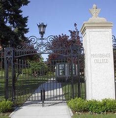 the entrance to providence college with an iron fence and gated in area behind it