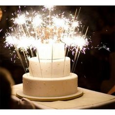 a white cake topped with lots of sparklers