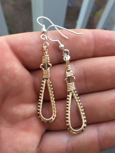 These dangle/drop earring were hand wrapped using only the finest Argentium Silver wire and 14 karat yellow gold filled wire. Intricately woven with time and care one piece at a time. Never mass produced. The ear hooks are fine Argentium Silver. Argentium silver is a finer quality than traditional sterling, yet is extremely resistant to tarnish. All of my Argentium silver is nickel free. They are light weight and are a unique, eye catching addition to any collection. Available in all silve Gold Wire-wrapped Teardrop Earrings, Gold Wire Wrapped Teardrop Earrings, Handmade Teardrop Gold Linear Earrings, Handmade Gold Teardrop Linear Earrings, Gold Dangle Hoop Earrings Wire Wrapped, Gold Wire Wrapped Teardrop Earrings For Gift, Yellow Gold Wire Wrapped Long Drop Earrings, Gold Wire Dangle Earrings, Gold Wire Earrings For Pierced Ears