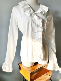 "A beautiful, snow-white 100% COTTON RUFFLED BLOUSE by \"LANZ SALZBURG-WIEN\" Made in Austria Gorgeous Ruffles around Neckline and down the Button Panel, as well as ruffled  sleeve cuffs Size is given as 38 = 8 actual measurements are: bust 38\" waist 34\" length 24\" great fabric, it rustles  VINTAGE, in excellent condition ps - the sun interferred a bit with the photographing...." Fitted White Shirt With Ruffles, White Ruffled Shirt For Formal Occasions, Formal White Ruffled Shirt, White Ruffled Blouse For Office, Fitted White Shirt With Ruffled Collar, White Fitted Shirt With Ruffled Collar, Elegant Fitted Shirt With Peter Pan Collar, Elegant White Shirt With Ruffled Collar, White Formal Shirt With Ruffled Collar