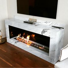 a modern fireplace in the middle of a living room