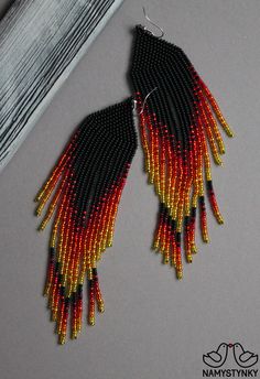 These fire red beaded earrings are made of high-quality Czech beads and strong synthetic thread. They are elegant, fashionable, and highly versatile, suitable for everyday wear. Features: Sterling silver components Color: black, red, yellow. This item is currently in stock. You must be completely satisfied. If you find merchandise unsatisfactory for any reason, return it within 10 days and your money will be refunded without questions. More beaded earrings http://etsy.me/2ycItdb Gerdan necklaces Traditional Red Earrings With Black Beads, Red And Black Beaded Drop Earrings, Red And Black Beaded Festival Earrings, Red And Black Beaded Earrings For Festival, Traditional Red Beaded Chandelier Earrings, Elegant Red Beaded Earrings For Festival, Red Beaded Earrings For Festival, Red Drop Earrings With Black Beads, Red Beaded Earrings With Black Round Beads