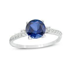 A colorful way to show your love, this engagement ring is the start of something beautiful. Crafted in cool 10K white gold, this adventurous style features a 7.0mm lab-created bright blue sapphire flanked by a pair of sparkling diamonds. Dainty diamonds line the shank for the perfect touch of shimmer. Radiant with 1/8 ct. t.w. of diamonds and a brilliant buffed luster, this engagement ring is a unique choice to celebrate your romance. Saffire Engagement Rings, Vintage Engagement Rings Sapphire, Stunning Engagement Ring, Dream Engagement, Dream Engagement Rings, Sapphire Stone, Engagement Rings Sapphire, Sparkle Diamonds, Something Beautiful