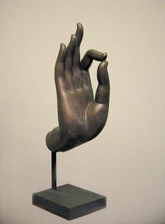 a sculpture of a hand holding something in it's palm