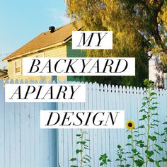 a white picket fence with the words my backyard apary design in black letters