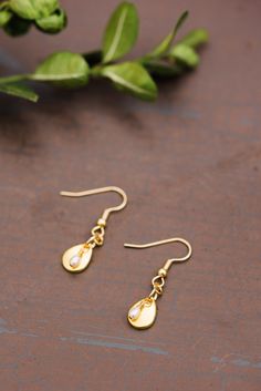 Tiny Teardrop Pearl Earrings – WAR Chest Boutique Dangle Brass Earrings With Pearl Charm, Brass Dangle Earrings With Pearl Charm, Dangle Earrings With Pearl Charm In Brass, Delicate Teardrop Pearl Drop Dangle Earrings, Gold Pearl Earrings With Brass Charm, Gold-tone Pearl Drop Dangle Earrings, Gold Teardrop Jewelry With Pearl Drop, Pearl Charm Teardrop Earrings As Gift, Pearl Charm Drop Earrings As Gift