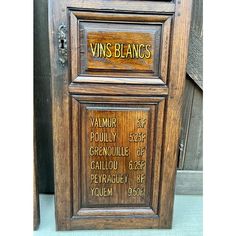 an old wooden cabinet with writing on the front and side panels that say, vins blanccs