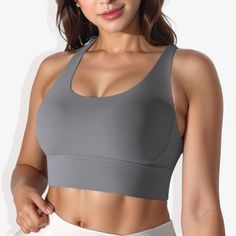 The Anna-Kaci Women's Scoop Neck Stretchy Cropped Banded Cup Seam Sports Bra is a stylish and functional addition to your activewear collection. This athletic top features a scoop neckline and a cropped design, providing a modern and sleek look. The banded cup seams and double-layering offer excellent support and a flattering fit. Made from 4-way stretch fabric, this sports bra ensures maximum flexibility and comfort during any workout. The padded cups add extra support and comfort, making it pe Gray Top With Built-in Bra And Medium Support, Sporty Tops With Medium Bust Support And Scoop Neck, Sporty Supportive Scoop Neck Top, Solid Scoop Neck Sports Top, Casual Top With Medium Bust Support For Sports, Casual Tops With Medium Bust Support For Sports, Solid Color Scoop Neck Sports Top, Gray Medium Support Sports Tank Top, Gray Sports Tank Top With Medium Support