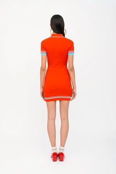 Our mini polo dress was first introduced in the summer of 2019 and has become a revered classic. For SS24 we updated her with preppy, sporty terry stripes at the trims, but she remains beautifully fitted and flattering as ever. This sophisticated, retro-active silhouette dons a 70s style collar and four functional buttons down the front. Do you love the new tomato color? Available in other colors and stripes. Our signature peachskin classics are instant wardrobe staples. They stand out for their Sporty Fitted Tennis Dress With Short Sleeves, Fitted Collared Polo Dress In Preppy Style, Fitted Casual Tennis Dress With Contrast Trim, Fitted Collared Preppy Polo Dress, Fitted Preppy Mini Dress, Fitted Casual Polo Dress With Polo Collar, Fitted Casual Polo Dress, Fitted Casual Polo Dress With Collar, Preppy Fitted Polo Dress For Summer