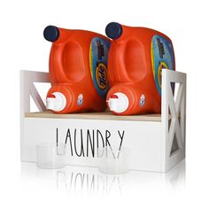 two orange plastic cups sitting on top of a white box with the word laundry written below them