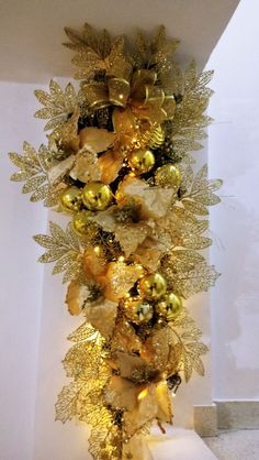 gold christmas decorations hanging on the wall