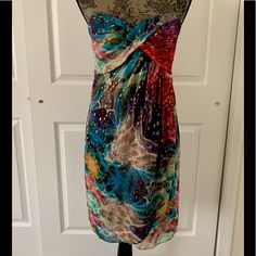 This A Beautiful Nwot Nicole Miller Strapless Multicolor Cocktail Dress. Sweetheart Neckline With Ruched Detail. Interior Includes Padded Cups. Hidden Back Zipper With Hook-And-Eye Closure. Lined. Material: 85% Silk, 15% Spandex; Lining: 100% Polyester Sleeveless Multicolor Print Mini Dress For Party, Multicolor Print Sleeveless Mini Dress For Party, Elegant Multicolor Strapless Dress, Elegant Multicolor Strapless Evening Dress, Elegant Multicolor Strapless Dress For Spring, Sleeveless Dresses With Vibrant Print For Evening, Sleeveless Evening Dress With Vibrant Print, Sleeveless Dress With Vibrant Print For Evening, Multicolor Sundress For Night Out