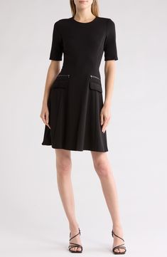 Zippered trims and front-flap pockets bring style points to this stem-baring dress cut in a timeless A-line silhouette. 36 1/2" length (size 6) Exposed back-zip closure Jewel neck Short sleeves Front flap pockets Partially lined 96% polyester, 4% spandex Dry clean Imported Black A-line Dress With Pockets, Seamed Knee-length Dress For Work, Knee-length Seamed Workwear Dress, A-line Office Dress With Pockets, Formal A-line Dresses With Pockets, Black Formal Dress With Pockets, Formal Black Dress With Pockets, Formal Black Dresses With Pockets, Seamed Midi Dress For Work