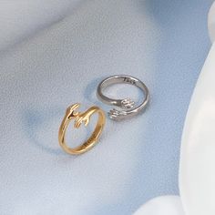 two rings sitting next to each other on a blue surface