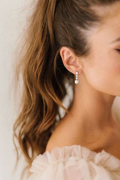 a close up of a person wearing some kind of earring on their left ear