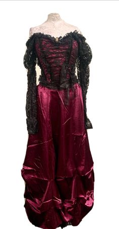 This is a rare vintage Raven outfit. The top has gathered black lace sleeves which can be worn both on  or off the the shoulders. The top has a zip in the back and medium fits a chest 34/36 inch .  The skirt it a plum satin and has an elasticated waist with a zip . Fits Up to a 36 inch waist. It also comes with a cameo brooch with diamanté . Thank you for looking Gothic Long Sleeve Corset Dress For Evening, Gothic Corset For Costume Party In Fall, Gothic Corset Dress For Costume Events In Fall, Gothic Corset Dress For Fall Costume, Gothic Corset Dress For Fall Costume Events, Vintage Corset For Halloween And Alternative Fashion, Vintage Corset For Halloween, Gothic Victorian Dress With Ruffles For Formal Events, Gothic Victorian Dress With Ruffles For Formal Occasions