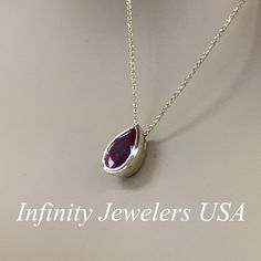 "The pendant pictured is a lab created red ruby #6930 -Approximate total carat weight: approx. 2.00ctw diamond equivalent -Center Stone Size: 10x7mm - approx. 2.00ct diamond equivalent -Center Stone Shape: pear -Gem Type: lab created ruby -Stone Clarity: AAA -Stone Color: Red -Moh's Scale: 9 hardness -Metal Type and Purity: 14k yellow gold -Setting: bezel set -Chain: delicate 14k gold chain / heavier option with lobster claw available (use dropdown to select) -Country of Manufacturing: USA (Mich Ruby Teardrop Pendant Jewelry, Formal Ruby Teardrop Pendant Jewelry, Classic Jewelry With Polished Lab-created Ruby, Pear-shaped Ruby Jewelry For Anniversary, Formal Ruby Necklace With Bezel Setting, Teardrop Ruby White Gold Jewelry, Teardrop Ruby Jewelry In White Gold, Anniversary Ruby Jewelry With Bezel Setting, Pear-shaped Ruby Gemstone Necklace