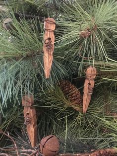 pine cones are hanging from the branches of a pine tree, which has been decorated with wood