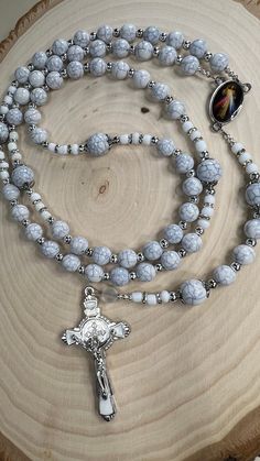 "Rosary of Jesus of Mercy made with light beads, 6mm and 8mm beads were used for the mysteries, the mysteries beads have a silver cap, 4mm silver spacers were used in addition to 6/0 Glass seed Beads white opaque Matte, the centerpiece of the rosary is of the Jesus of Mercy Mercy measuring 1\" or 2.5 cm, the rosary crucifix is in white and silver measuring 2\" or 2.5 cm. The measurement of the rosary is 22.5 inches or 57 cm. Beautiful instrument of prayer or to give as a gift." White Spiritual Rosary Bracelet, White Rosary With 8mm Beads For Meditation, White 8mm Beads Rosary For Meditation, White Faceted Spiritual Beads, Adjustable Rosary With Faceted Round Beads, White Rosary With Round Beads For Meditation, White Spiritual Rosary Bracelet With 8mm Beads, Healing Rosary With Miraculous Medal And Round Beads, White Crucifix Rosary With Miraculous Medal