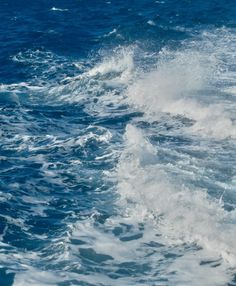 the water is very choppy and blue with white foamy waves on it's surface