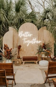 an outdoor ceremony setup with wooden chairs and palm trees