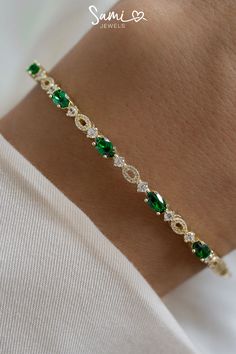 A pin of our emerald bangle that has emerald gemstones, diamonds, and gold. Elegant Green Oval Bangle, Elegant Oval Green Bangle, Elegant Green Stackable Bracelets, Elegant Cubic Zirconia Bracelets For May Birthstone, Elegant Green Cubic Zirconia Bracelets, Jewelry Gold Bracelet, Gold And Emerald, Jewelry Emerald, Bracelet Diamond