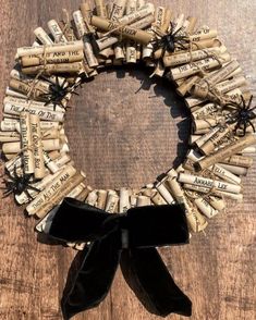 a wreath made out of wine corks and black ribbon